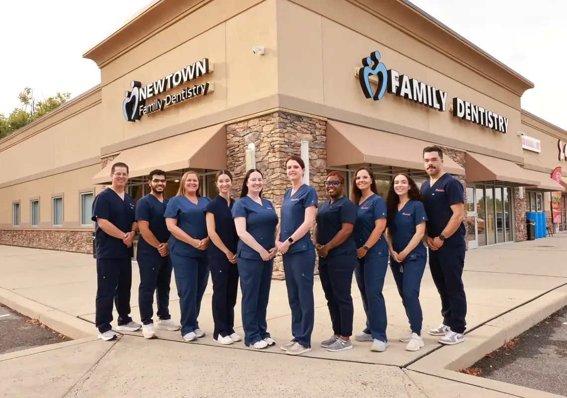 Newtown Family Dentistry Team standing in front of the office building