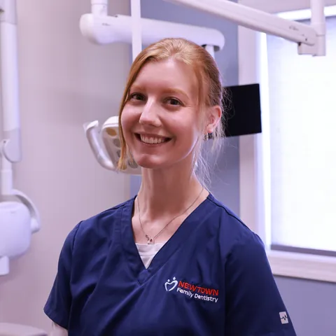Kristen, Dental Assistant at Newtown Family Dentistry, smiling in a treatment room